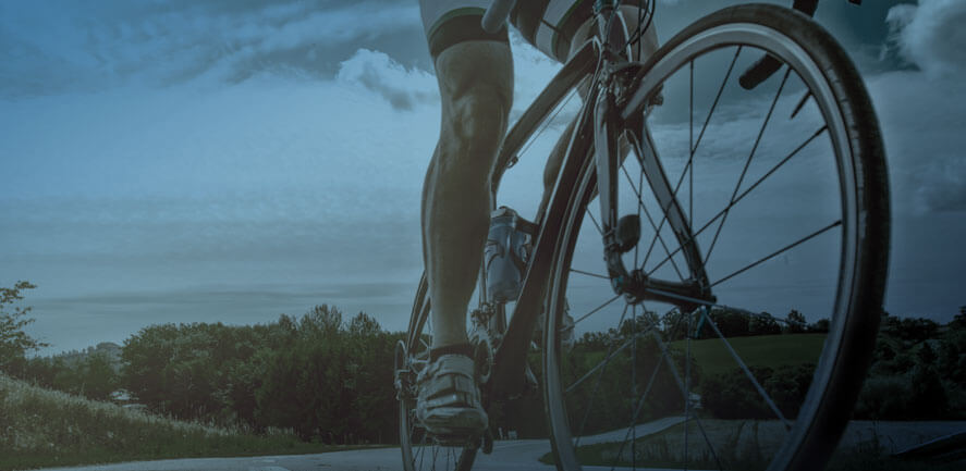 legs of man in bike shorts riding bicycle 