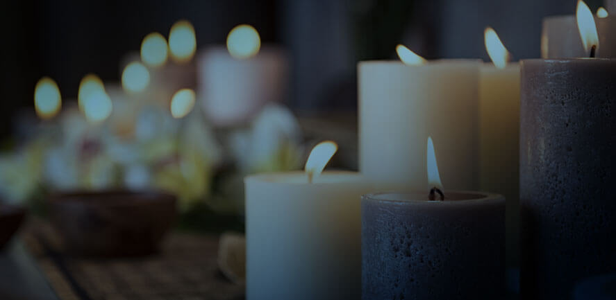 vigil candles of different sizes lit with flame | Wisconsin wrongful death attorney