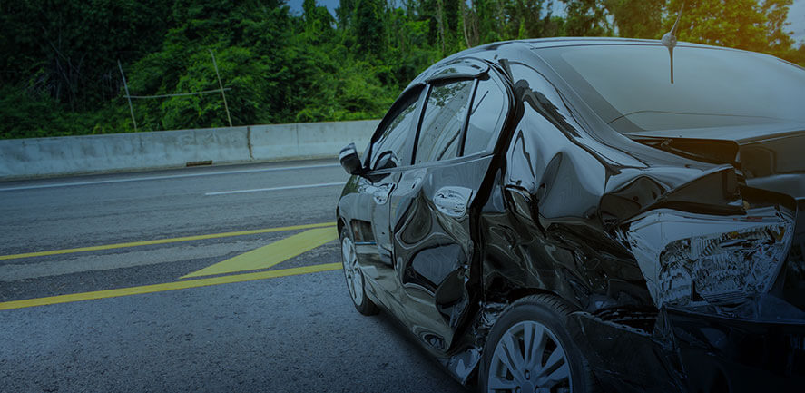 Black car smashed in on driver's side after a car accident | Wisconsin car accident lawyer