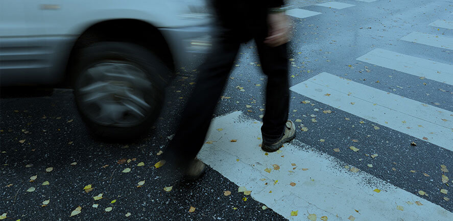 Pedestrian walking through crosswalk