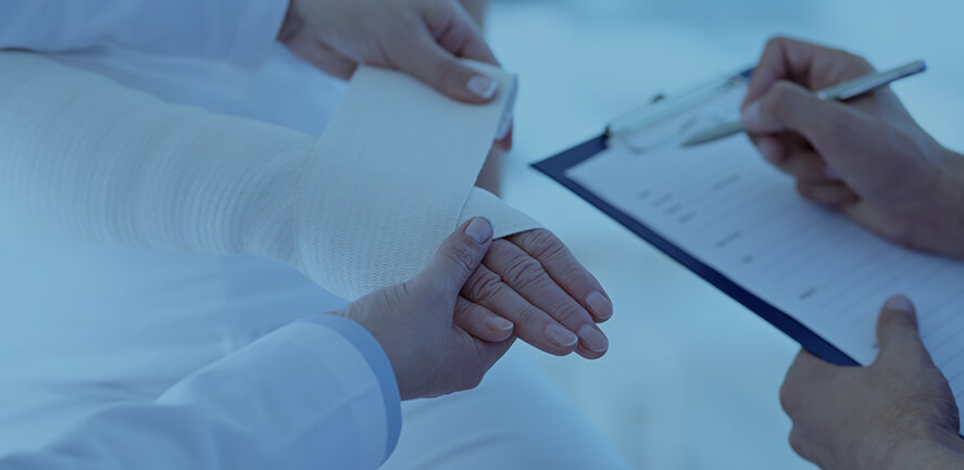 doctor wrapping patient's hand 