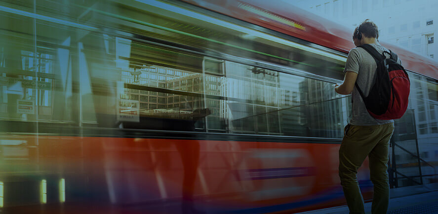 man waiting as pubic bus drives by